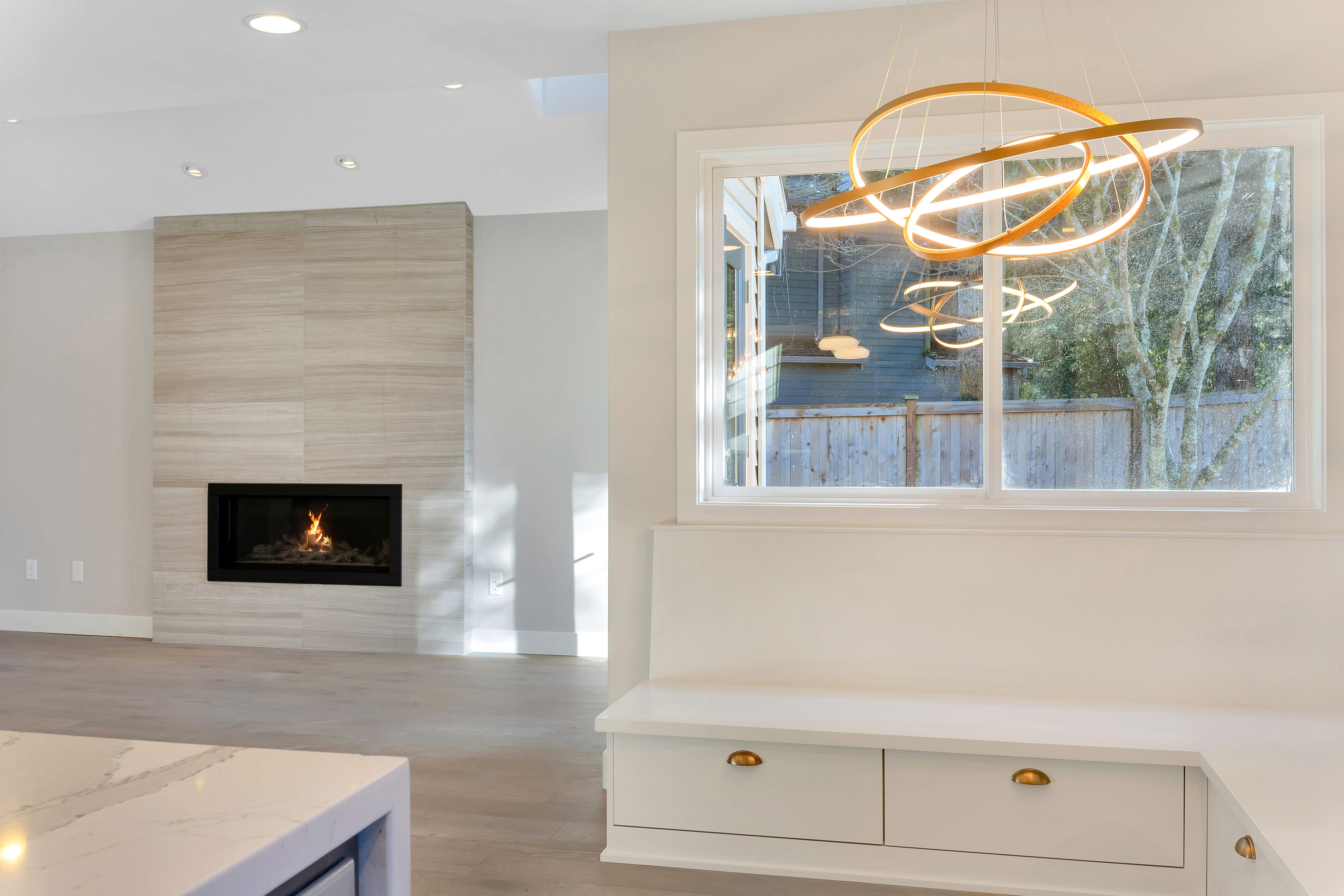 Open kitchen and living space with fireplace, Modern Moment remodel