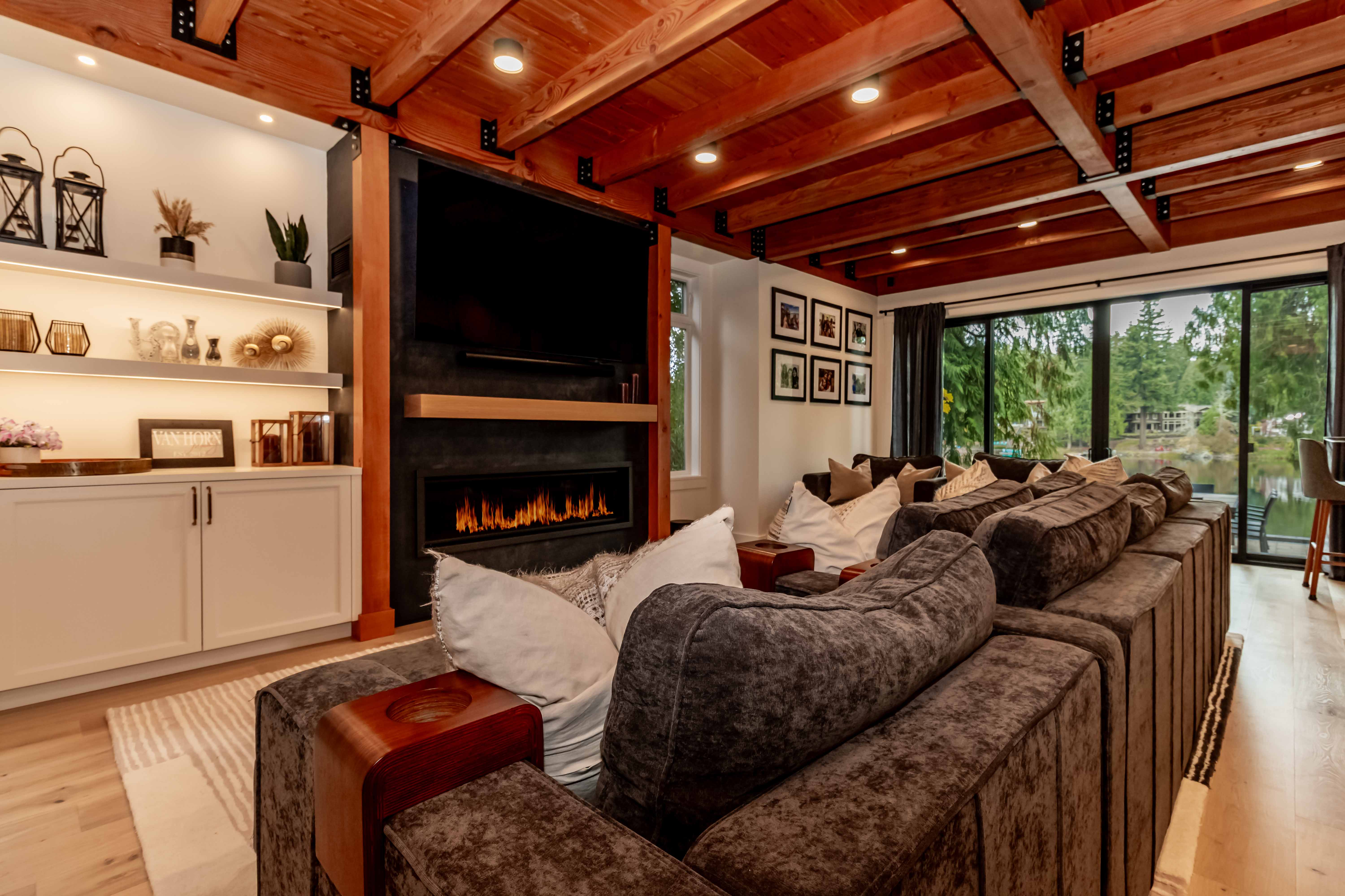 Family room with linear fireplace, sectional, and exposed beams, Beaver Lake