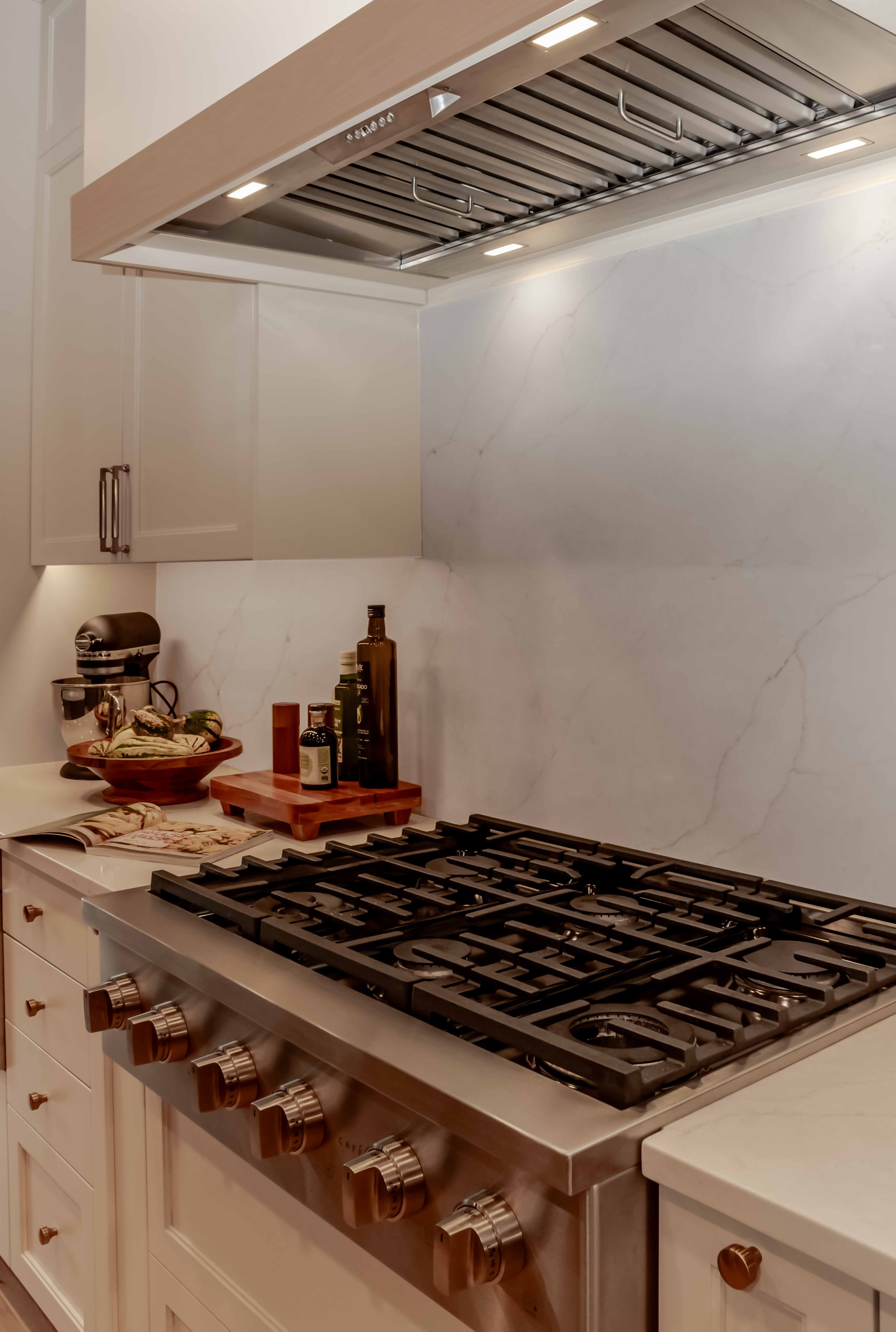 Kitchen detail with gas range and marble backsplash, Beaver Lake