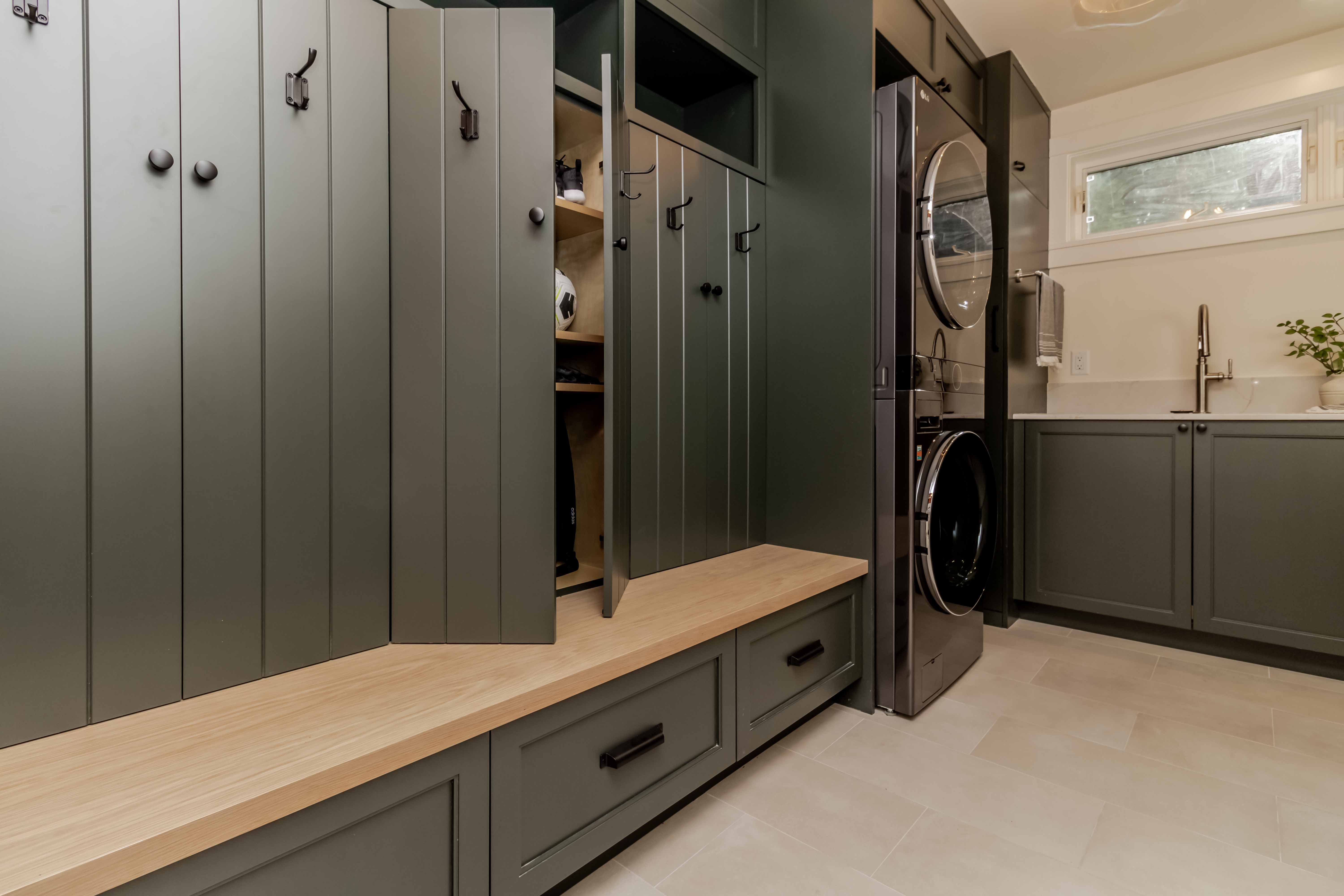 Laundry and mudroom with green built-in cabinets and bench, Beaver Lake