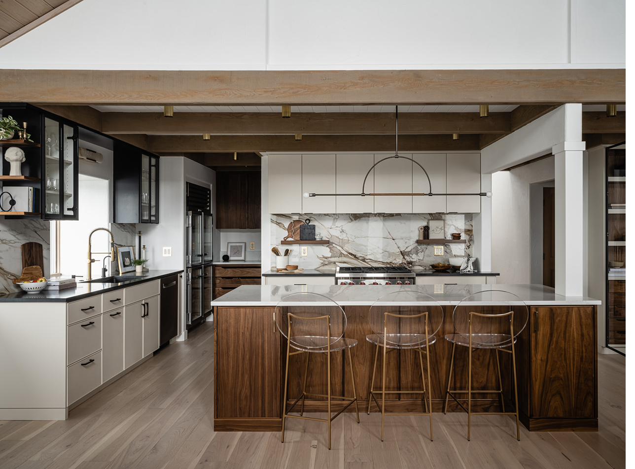 Whitestone kitchen with marble backsplash, walnut island, and vaulted ceiling