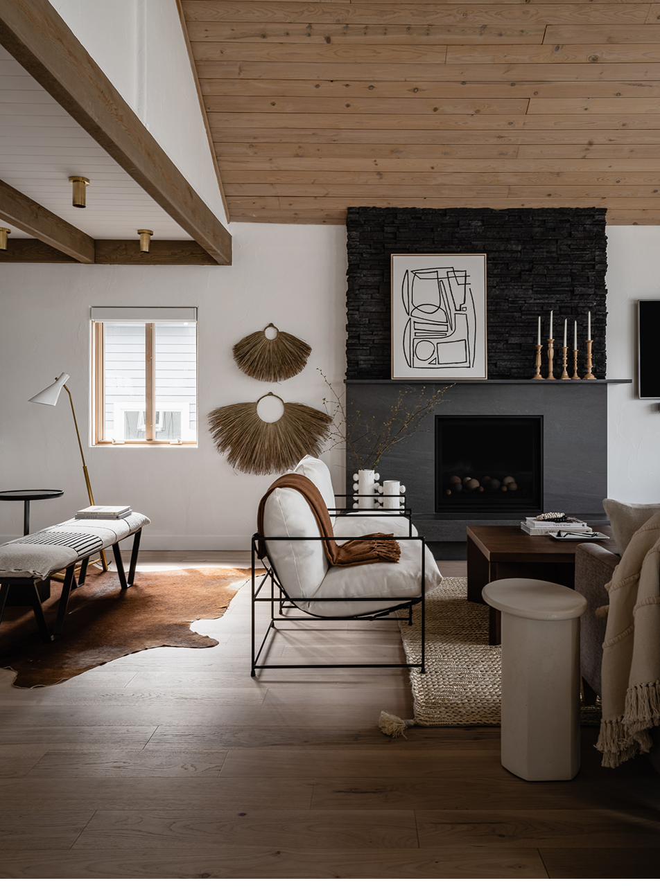 Whitestone living room with stone fireplace and vaulted cedar ceiling