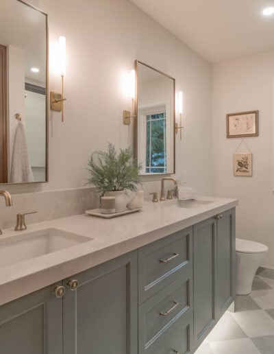 Guest bathroom remodel in North Bend with a quartz double vanity, brushed gold fixtures and checkerboard tile floor