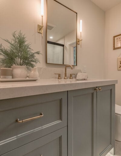 Double vanity with framed mirrors, sconce lighting and a quartz countertop