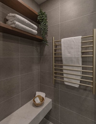 Heated towel rack and tile shower bench detail in a primary bathroom