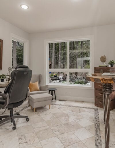 Home office remodel in North Bend with a built-in desk, glass French doors and natural light